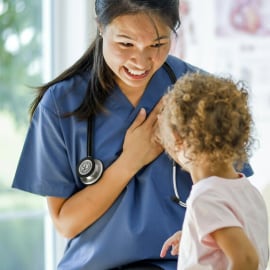 Female doctor smiling at child patient.